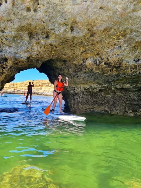 Albufeira: Caves and Beaches SUP Paddleboarding Tour - Entering the caves by paddleboard