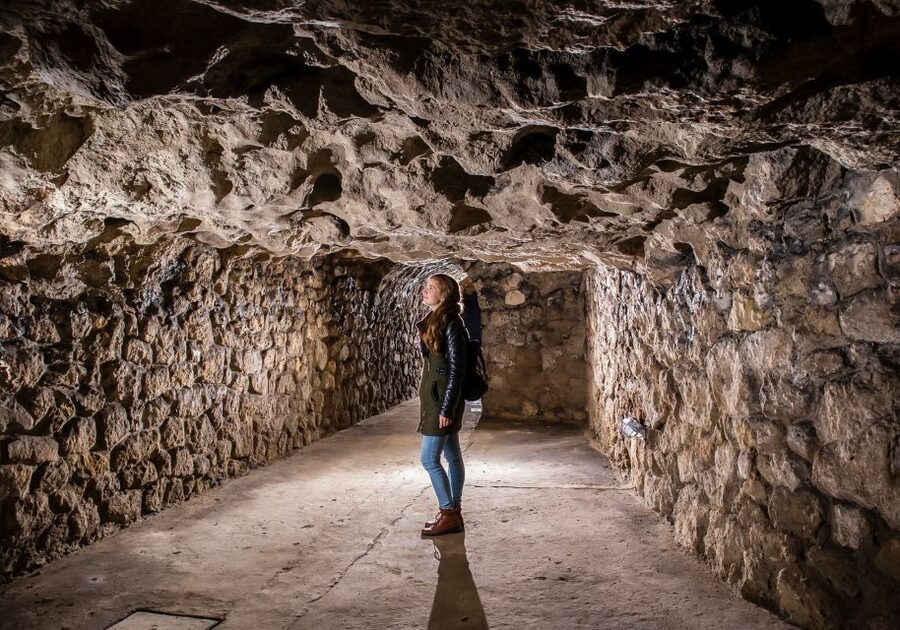 Budapest: Buda Castle Cave Tour - Natural limestone beside human-made cellars
