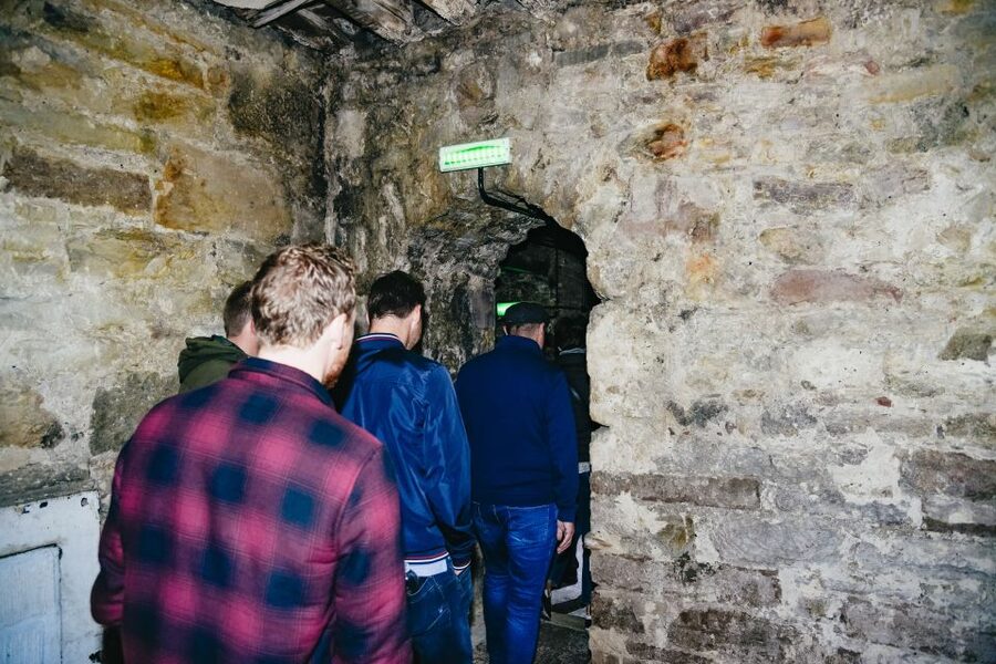 Edinburgh: Underground Vaults Tour - Entering the low, dimly lit vaults