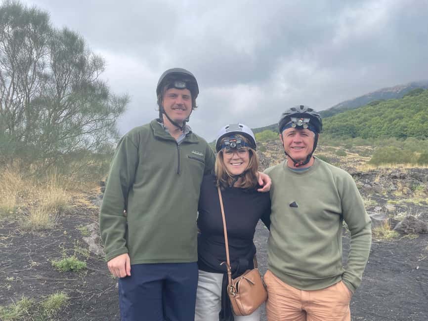 Etna Jeep Tour: Explore Craters and Lava Caves, Etna Wine Brunch - Entering an Etna lava cave with helmet and flashlight