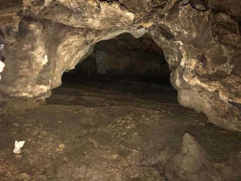 From Tirana: Hiking to Pellumbas Cave & visiting the Canyon - Entering the Black Cave with helmet and torch