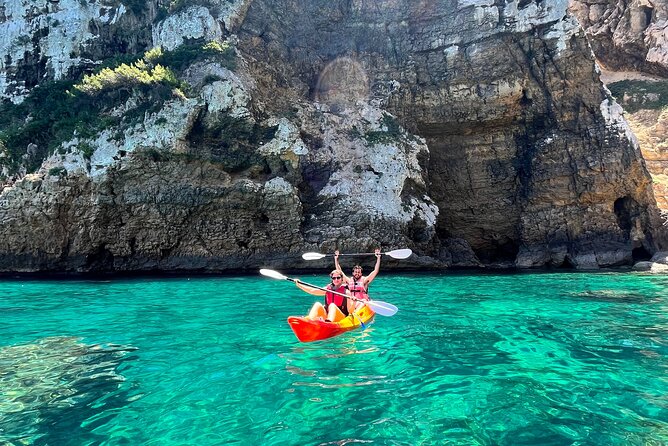 Kayak Paradise: Cala Portixol Snorkel, Cave & Cliff Jumping Tour - Entering Isla de Portixol’s cave and blue lagoon