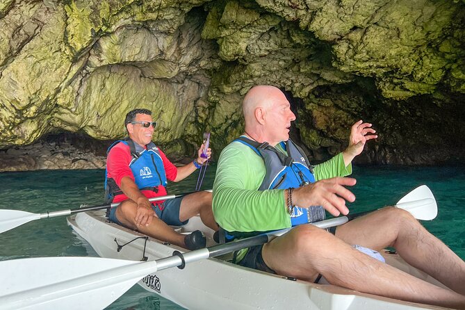 Kayak tour in Capri between caves and beaches. Photos included. - Getting close to the Faraglioni