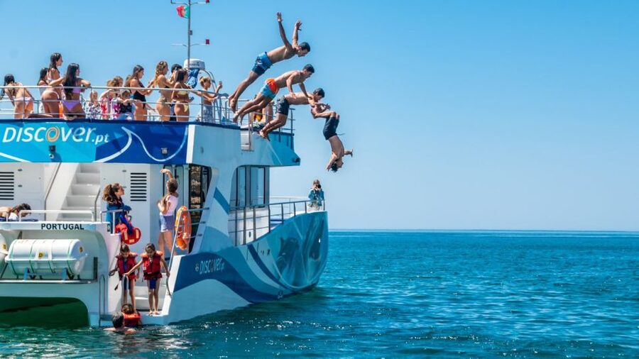 Lagos: Dolphins & Caves - Catamaran - Swimming, jumping, and the inflatable slide