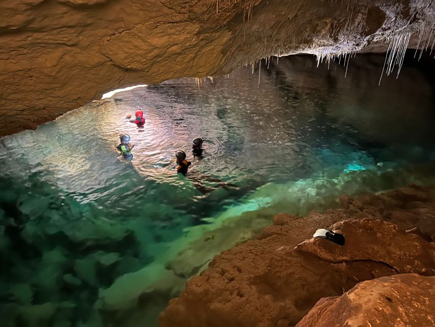 Mallorca: Aquatic Cave Exploration Guided Tour - Entering the cave with a helmet and headlamp