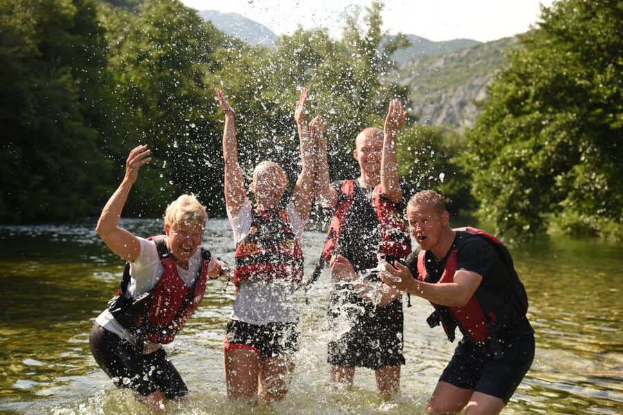 Split: Cetina River Rafting with Cliff Jumping and Cave Tour - Swimming beneath a spring waterfall