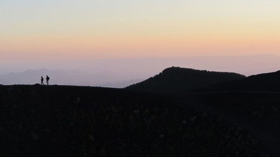 Taormina: Mount Etna Sunset Tour with Cave Visit and Tasting - Walking near Rifugio Sapienza at sunset