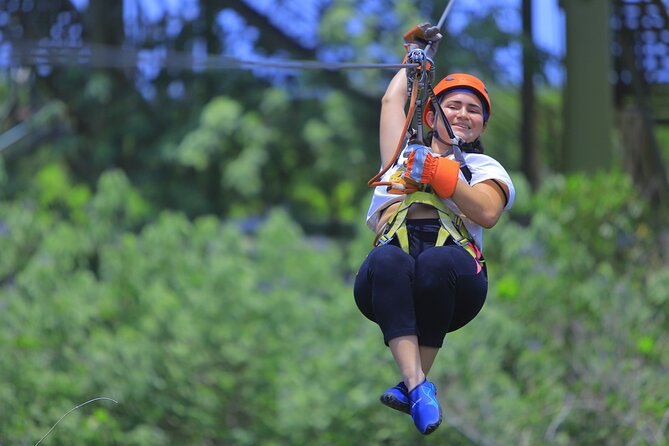 Top ATV's in Mexico includes Cenote, Ziplines, snack & transport. - Ziplining above the trees