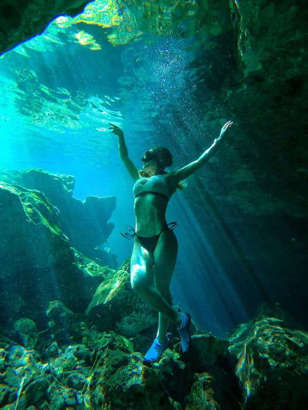 Tulum: Hidden Cenotes Bike Tour - Experience with Locals - Second stop: sunlight, clear water, and a semi-open setting